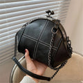 Women's Black Kiss-Lock Cross-Stitch Shoulder Bag - primary photo, shown with a person (1 of 2)