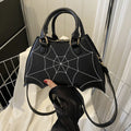 Women's Black Spiderweb Bat-Wing Handbag - primary photo, shown with a person (1 of 2)