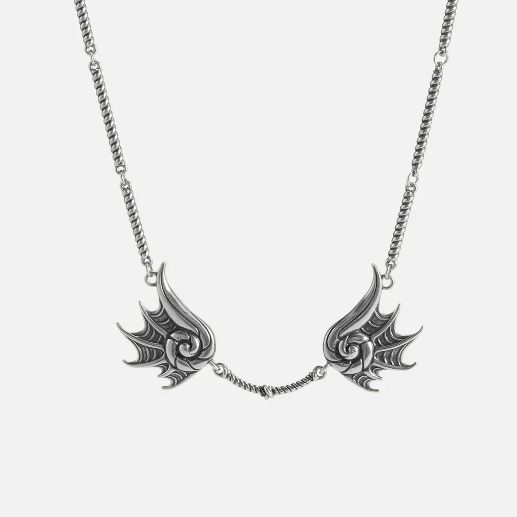 Silver Abyssal Bind Necklace with twin conch-like forms, shell ridges, central rope chain detail, and antiqued finish on a clean background.