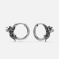 Adaptive Evolution Earrings in 925 sterling silver, pair shown on white, featuring small sculpted dragon forms wrapped around