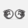 Pair of silver-tone alien invasion tunnels with ridged spine detail and coiled creature motif, front view