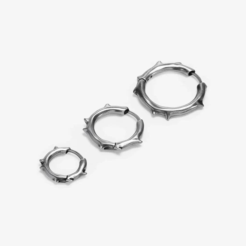 Silver-tone Ancient Thorn Hoops are shown in multiple sizes with thorn-shaped spike details.
