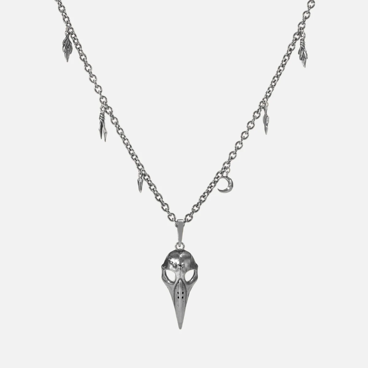 Augur Skull Necklace in silver plating with bird skull pendant, leaf charms, and antiqued finish