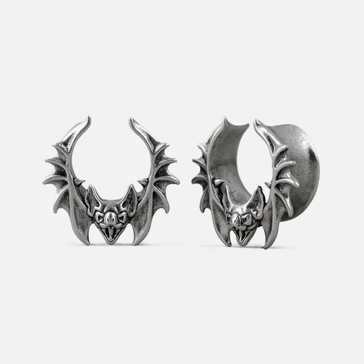 Silver-tone bat whisper tunnel earrings with detailed wings, shown front and side view
