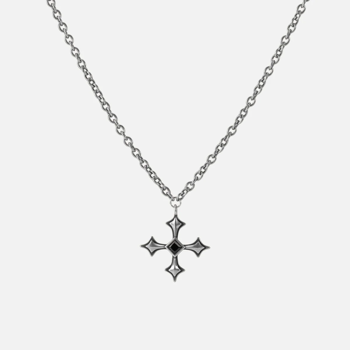 Black Testament Necklace in antiqued silver with a gothic cross pendant and black obsidian, shown full length on white.
