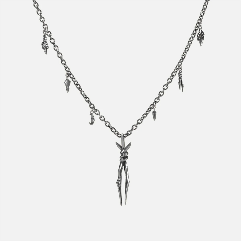 The silver-tone Bound Twin Necklace features a twin spike pendant, leaf charms, and an antiqued finish.