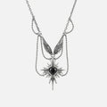 Silver-tone layered necklace with a winged eye starburst pendant and dangling spike