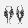 Pair of oxidized silver-tone celestial wing earrings with hoop closures shown against a white background