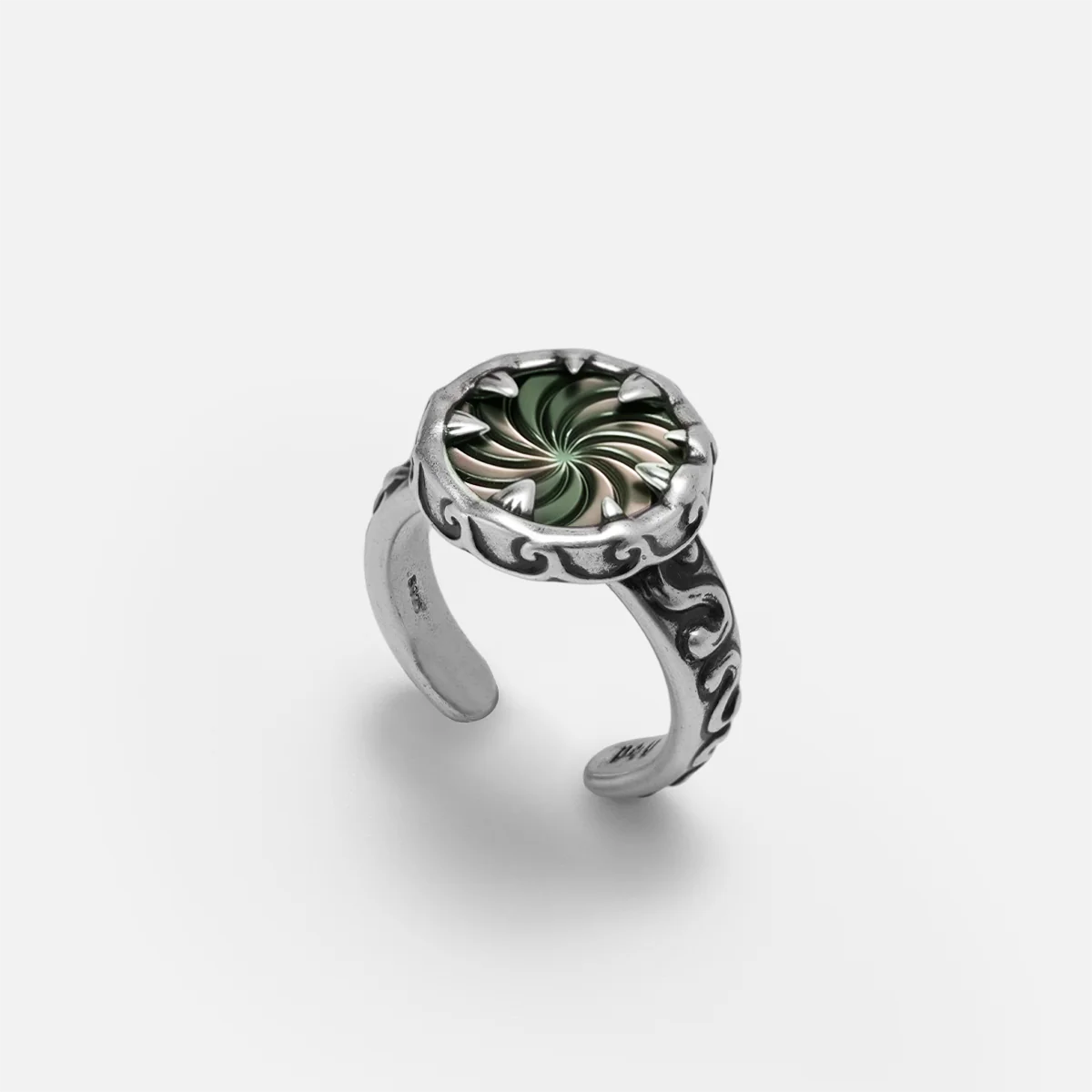 Charybdis Maw Ring in antiqued silver with swirling abalone shell center, carved wave-like edges, and open ring design on a clean background.