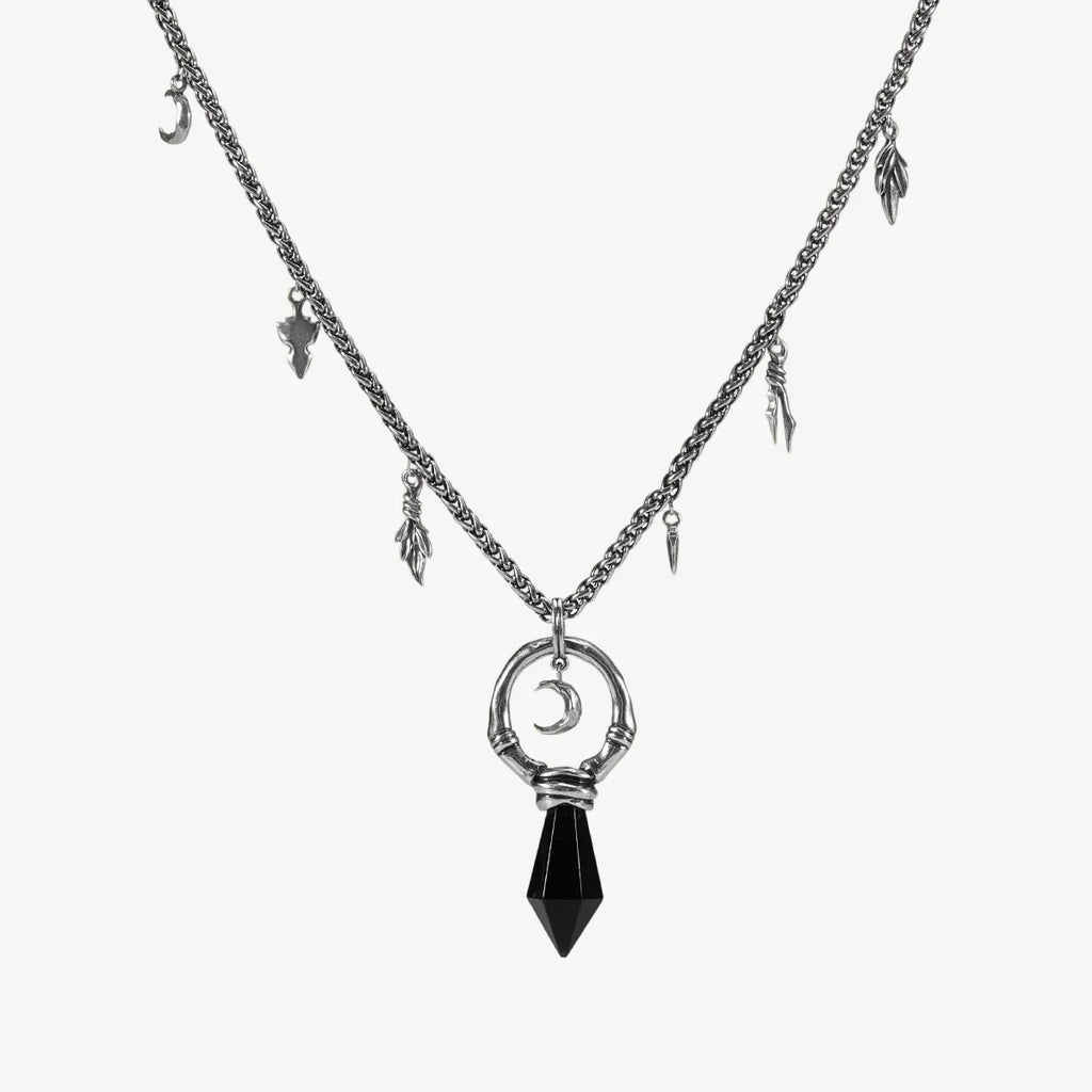 Silver Crescent Ward Necklace with black obsidian spike pendant, crescent moon charm, bone ring detail, and leaf-and-tooth chain accents on a clean background.