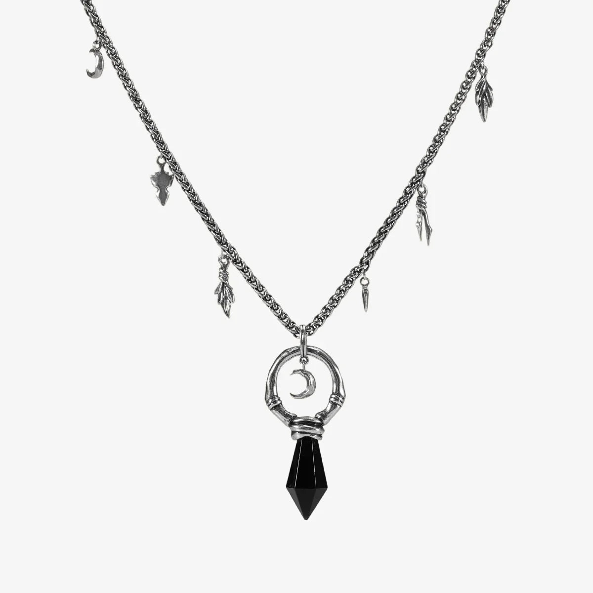 Silver Crescent Ward Necklace with black obsidian spike pendant, crescent moon charm, bone ring detail, and leaf-and-tooth chain accents on a clean background.