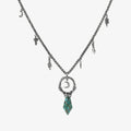 Crescent Ward Necklace in silver plating with crescent moon ring, turquoise spike pendant, and antiqued finish