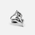 Silver-tone crest shield ring with pointed shield motif and small dark stone, shown at an angle