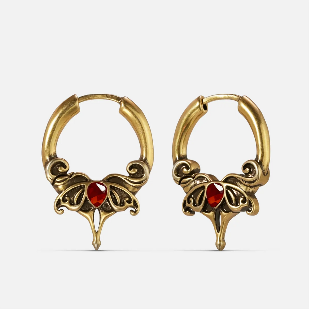 Gold-tone Crimson Wing hoop earrings with red teardrop stones and ornate pointed wing details