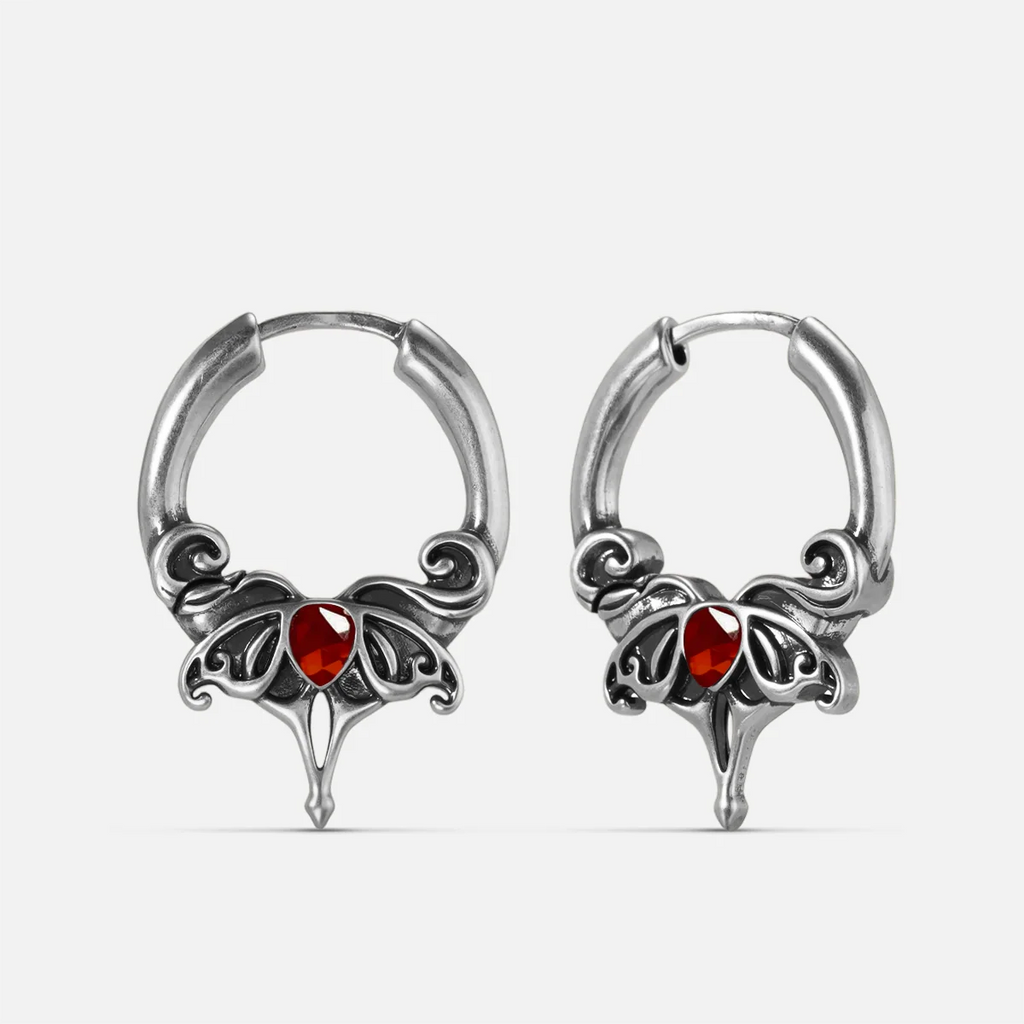 Silver-tone Crimson Wing hoop earrings with red teardrop stones, scrolling wings, and pointed drops