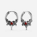 Silver-tone Crimson Wing hoop earrings with red teardrop stones, scrolling wings, and pointed drops