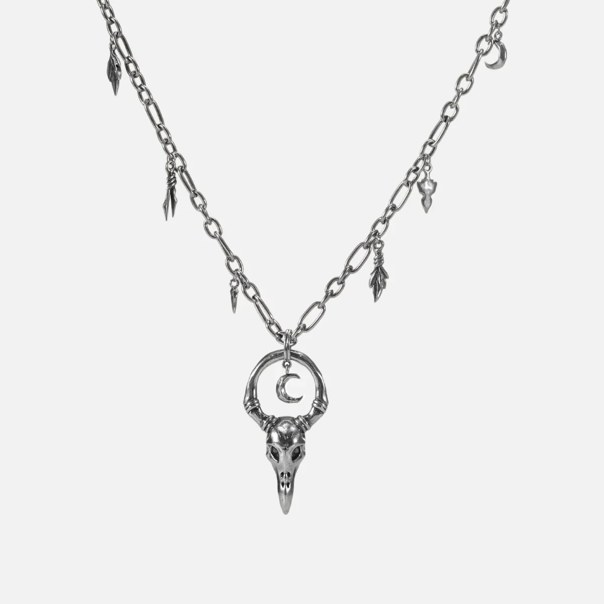 Crow Ward Necklace in silver plating with bird skull pendant, crescent moon detail, and antiqued finish