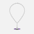 Silver-tone chain necklace with a purple crystal prism pendant wrapped in metal rings, shown flat against a plain background