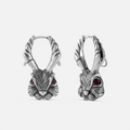 Pair of oxidized silver-tone jackalope hoop earrings with antlers and red gemstone eyes, front view