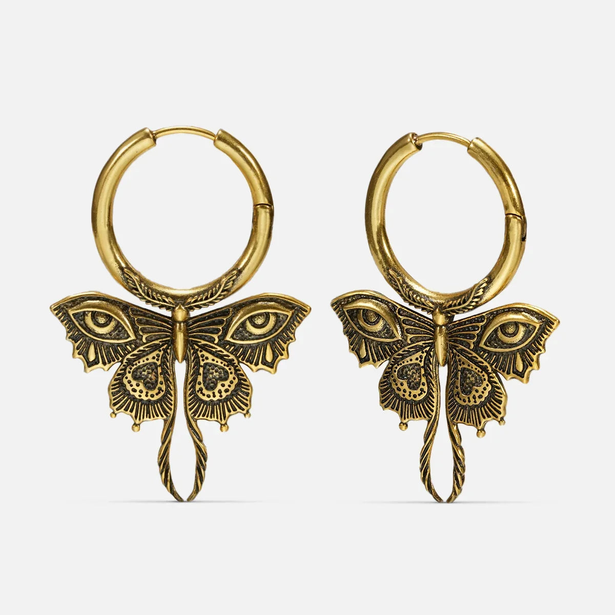 Pair of gold-tone Enchanted Moth hoop earrings with engraved wings, eye details, and long curled tails
