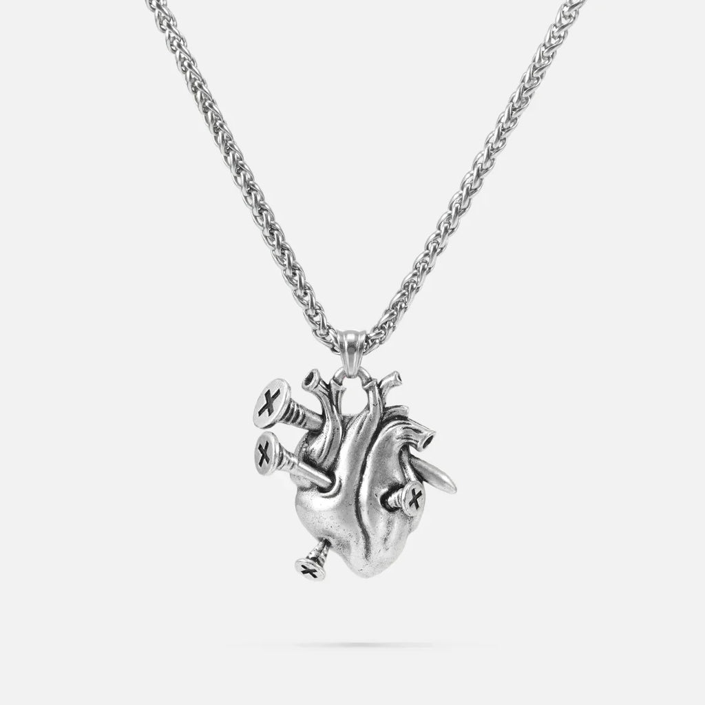 Silver-tone chain necklace with a sculpted anatomical heart pendant