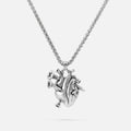 Silver-tone chain necklace with a sculpted anatomical heart pendant