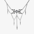 Silver-tone necklace with an ornate filigree centerpiece, clear stone, layered chains, and spike charms