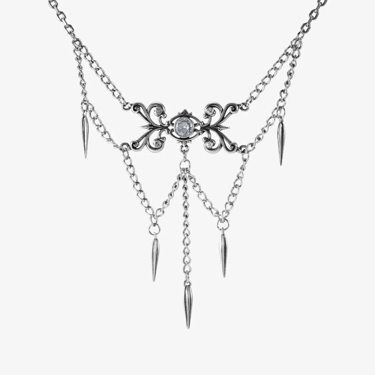 Silver-tone necklace with an ornate filigree centerpiece, clear stone, layered chains, and spike charms