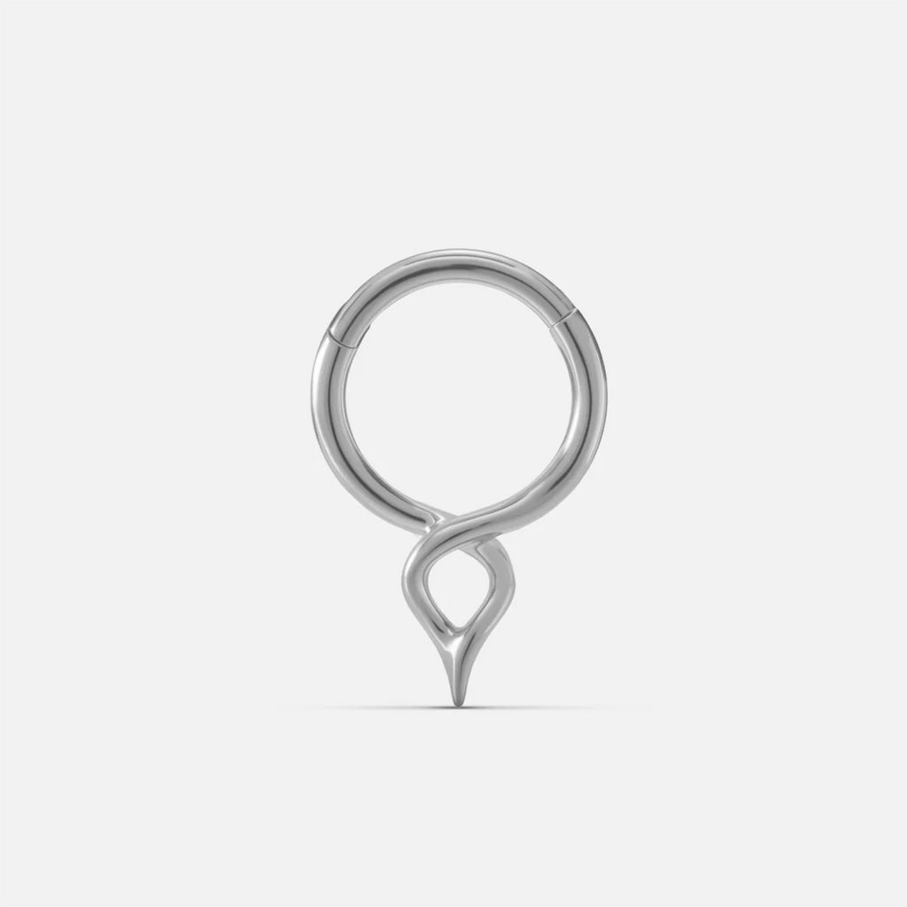 Silver-tone twist clicker ring with a small teardrop drop, shown front facing on a plain background