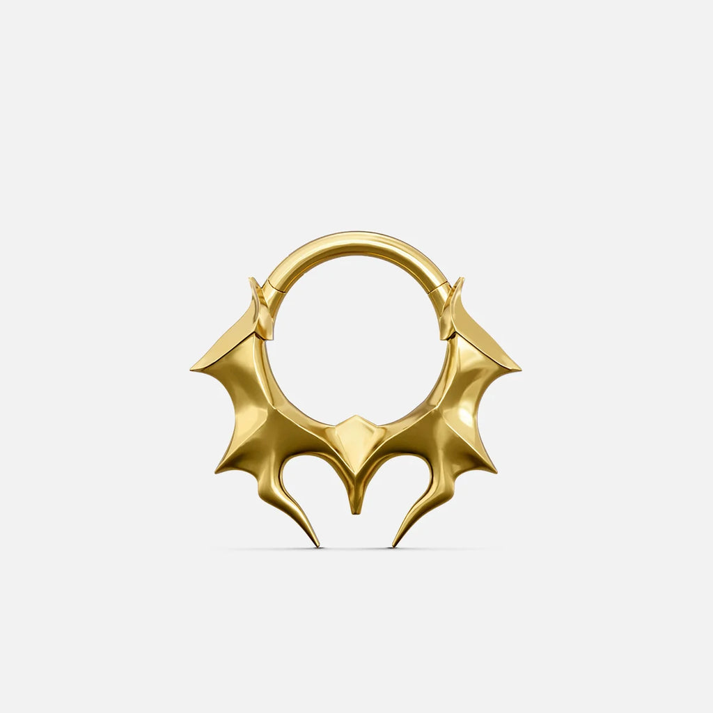 Gold-tone Infernal Horn Clicker with sharp symmetrical horn accents and an angular lower silhouette.