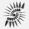 Black stainless steel ear tapers of various gauges arranged in a spiral pattern on a light background