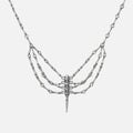 Silver-tone spine necklace with layered chains and a spike pendant, shown flat on a plain background