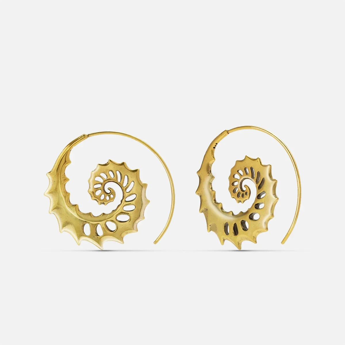 Gold Nautilus Omen Earrings with spiral shell forms, cutout ridges, thorn-like edges, and hoop design on a clean background.