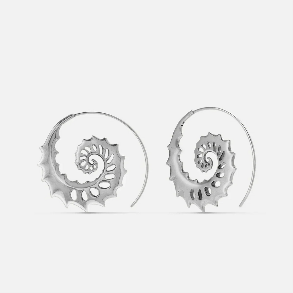 Silver Nautilus Omen Earrings with spiral shell shapes, cutout ridges, thorn-like edges, and hoop design on a clean background.