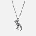 Silver-tone chain necklace with a dinosaur skeleton pendant shaped like a T-rex, laid flat