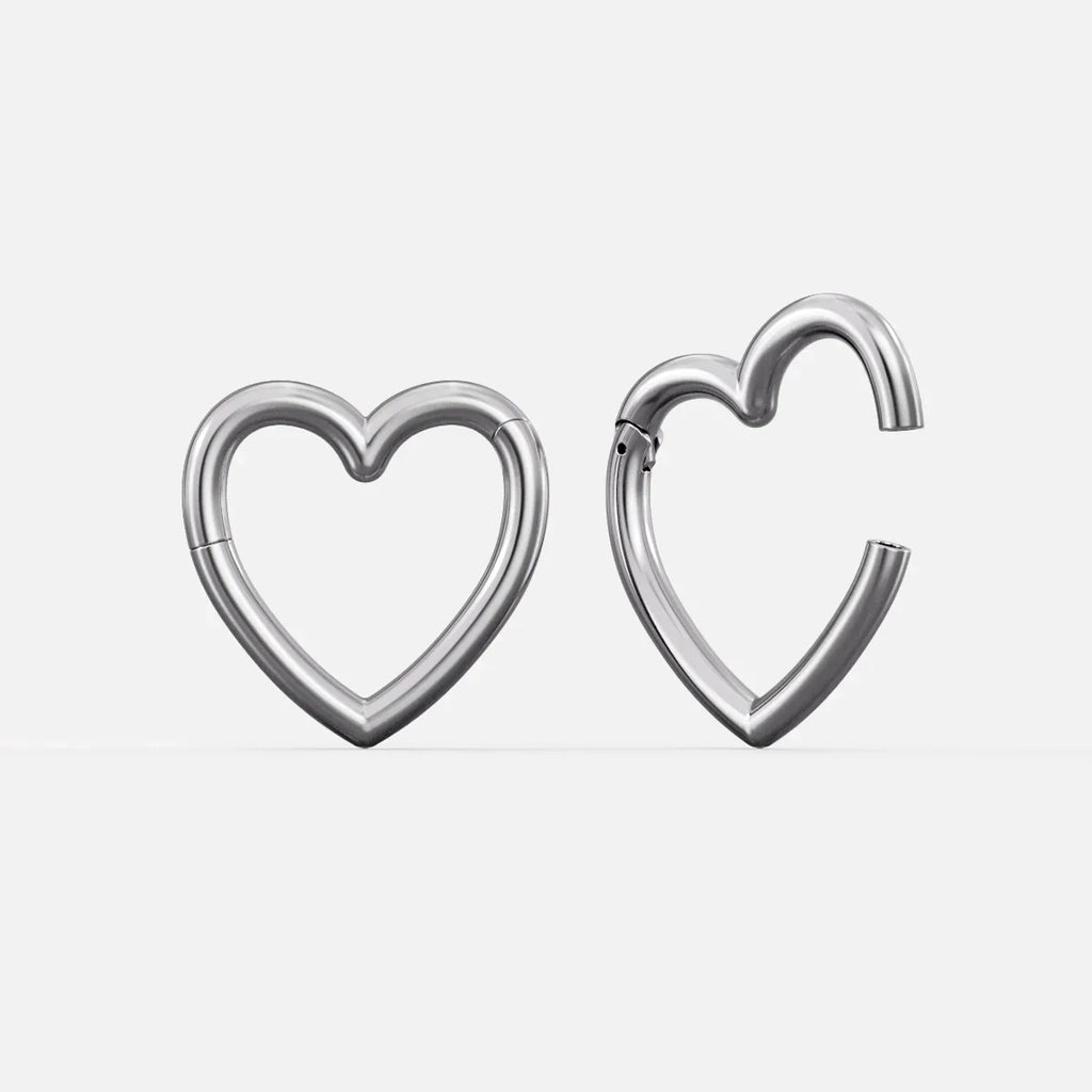 Silver-tone heart-shaped hinged ear weights, one closed and one open showing the clasp