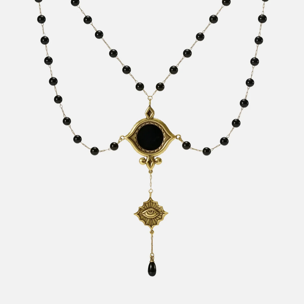 Gold-tone Scrying Mirror Necklace displayed from the front with doubled black bead chains, an oval black obsidian centerpiece, and a teardrop accent.