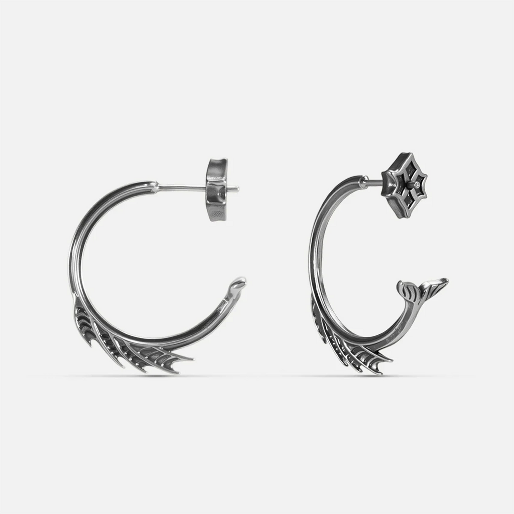 Silver Siren Crest Earrings with fin-like ridges, sculptural half-hoop shape, and 925 silver posts on a clean background.