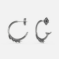 Silver Siren Crest Earrings with fin-like ridges, sculptural half-hoop shape, and 925 silver posts on a clean background.