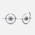 Silver-tone Stellar Grace hoop earrings with spike accents and a purple stone center, shown front and side view