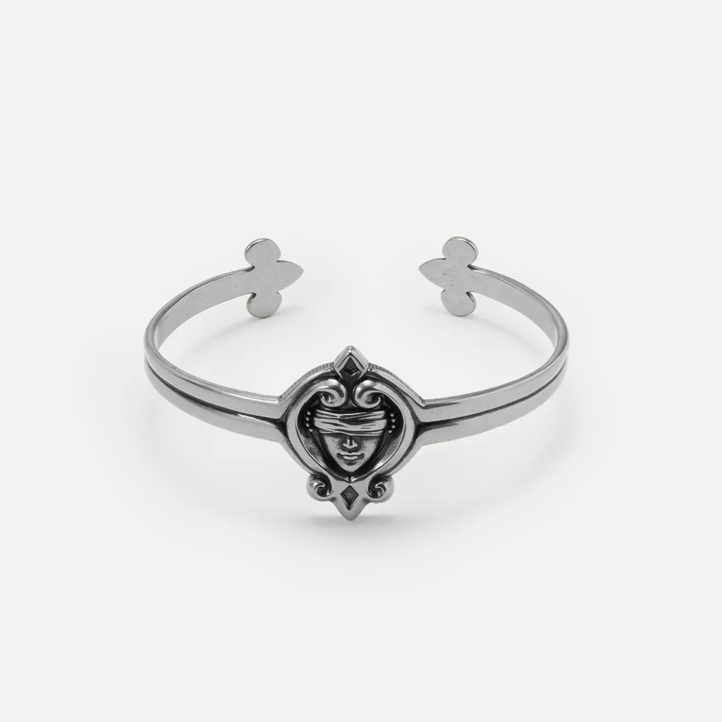 Antiqued silver-tone Veiled Seer Cuff Bracelet with a blindfolded face motif, pointed ornamental frame, and open cuff design.
