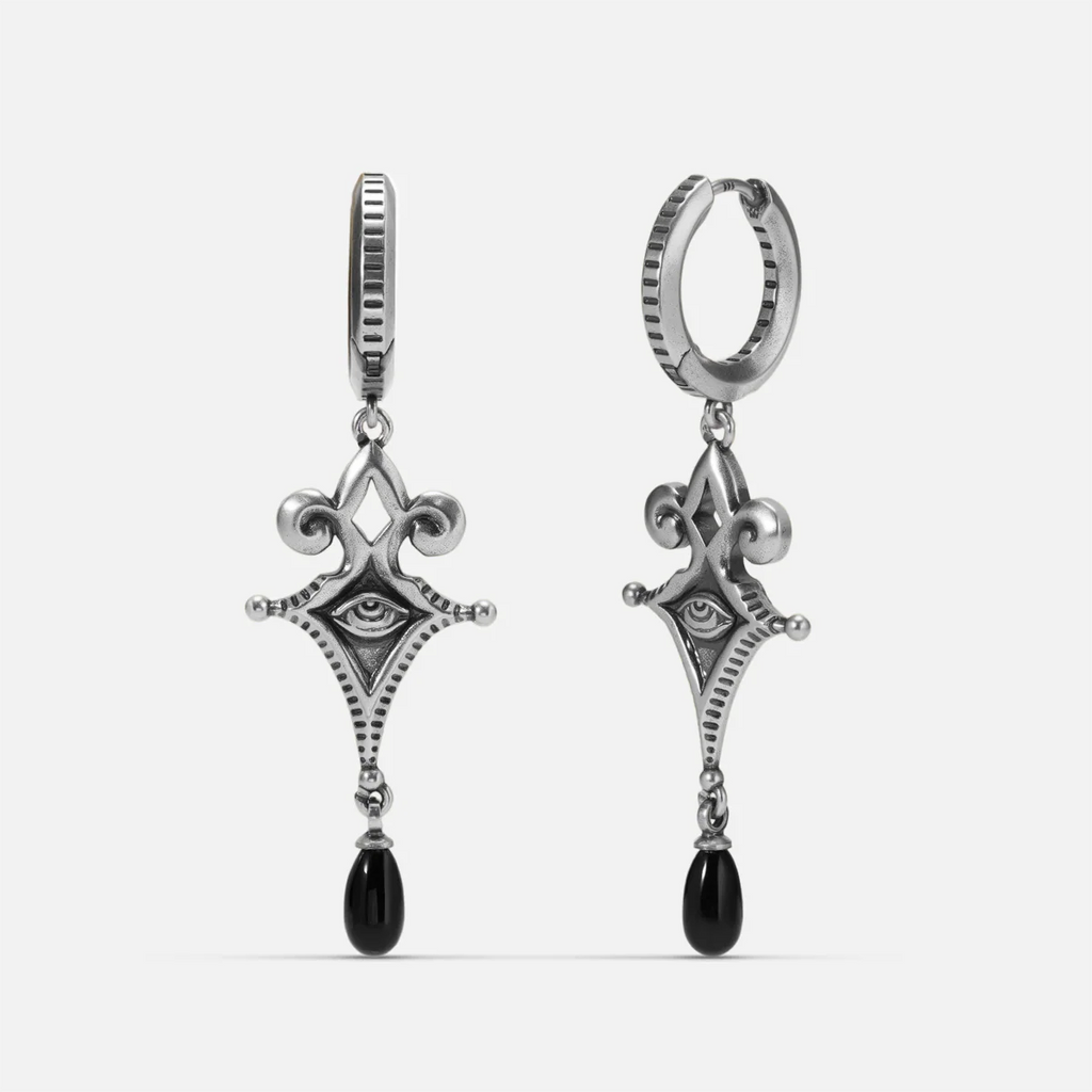 Antiqued silver-tone Watcher’s Tear Earrings shown from front and side views with engraved eye motifs and suspended black teardrop accents.